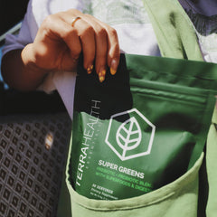 Terra Health Essentials Super Greens label close-up showing glyphosate-free and allergen-friendly formula.