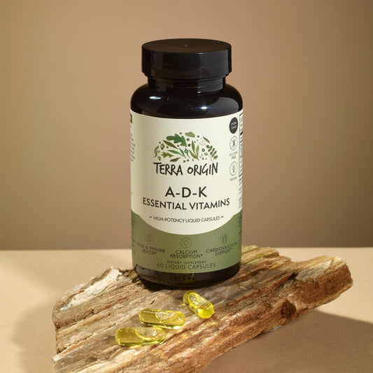 Close-up of Terra Origin ADK liquid capsules for high absorption and easy swallowing.
