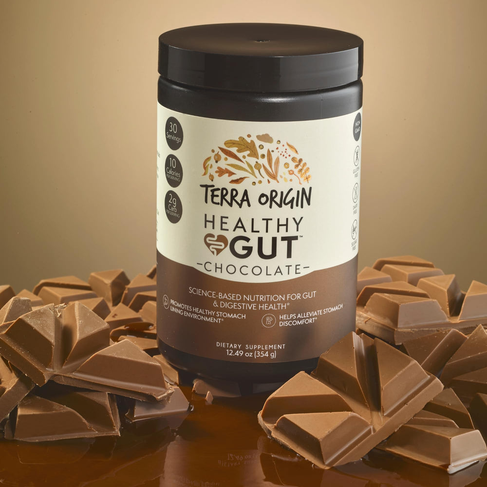 Pouring Terra Origin Healthy Gut into water showing smooth chocolate shake texture
