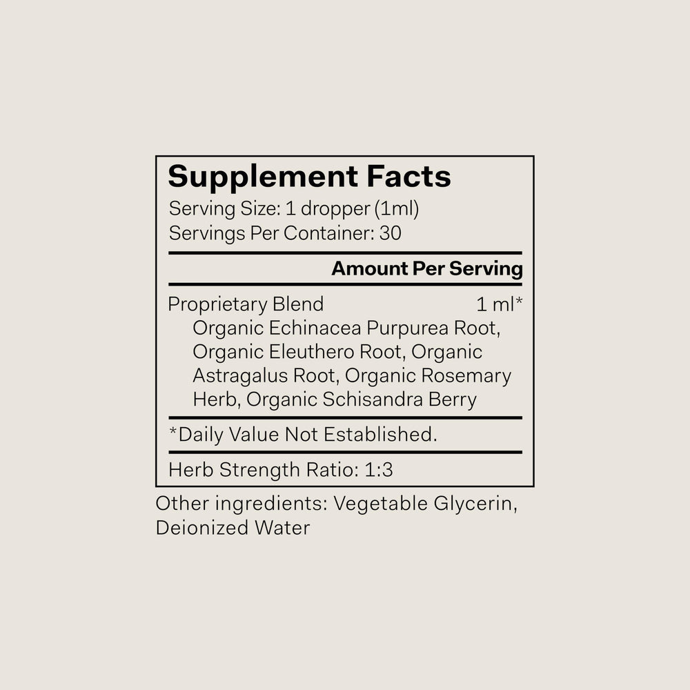 The Nue Co Defense Drops bottle side label shows vegan, alcohol-free formulation for mindful living.