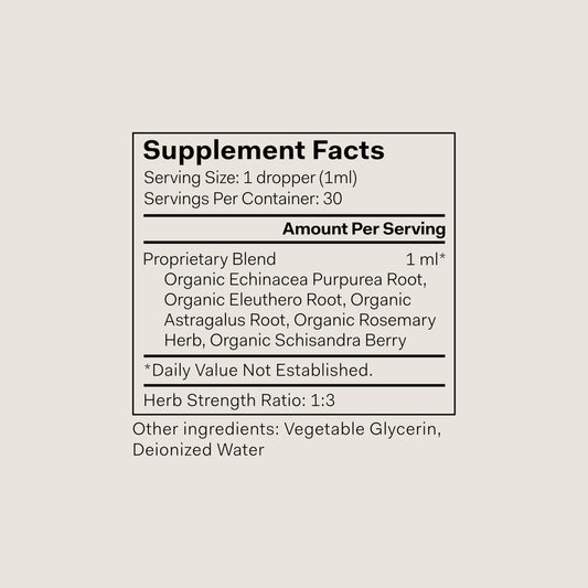 The Nue Co Defense Drops bottle side label shows vegan, alcohol-free formulation for mindful living.