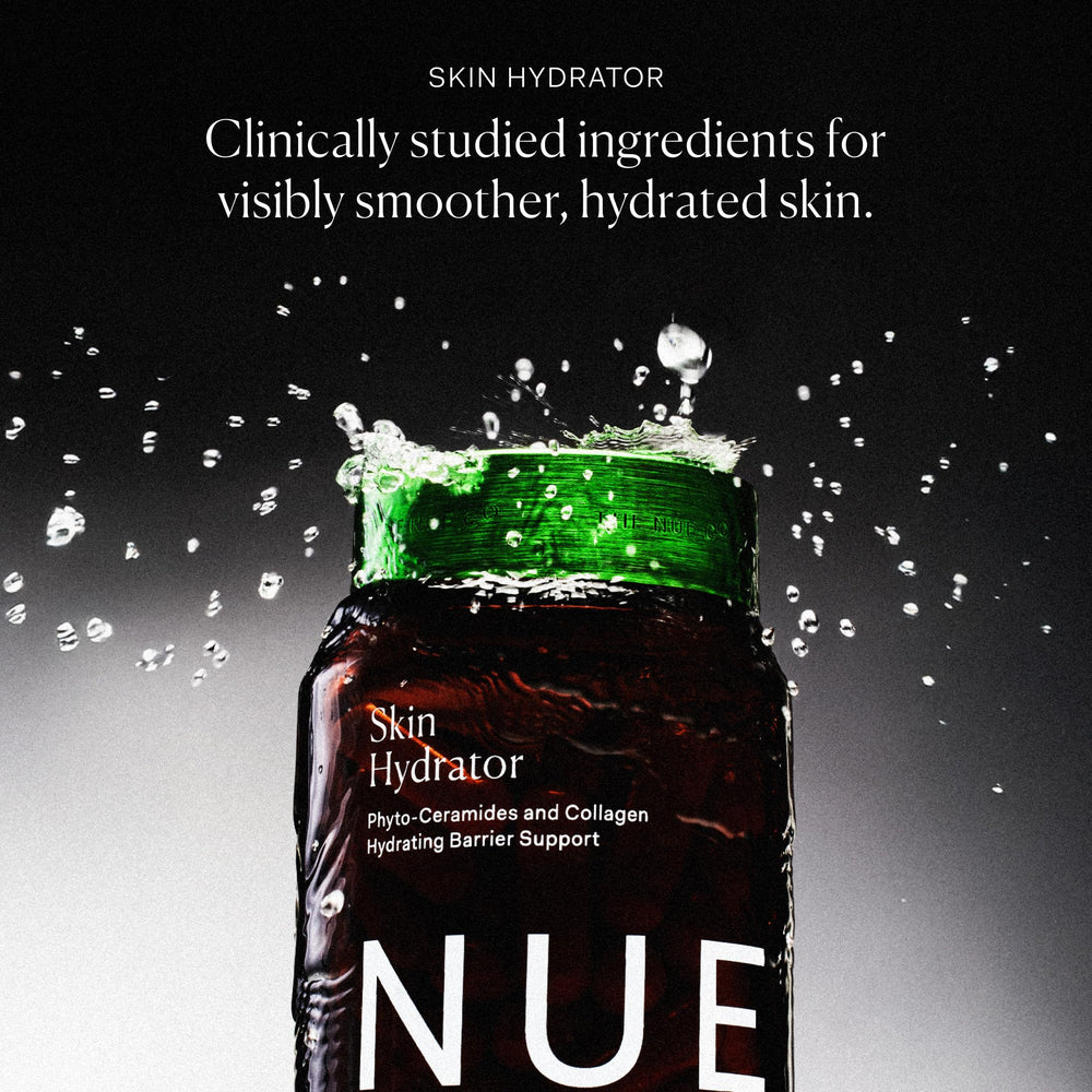 The Nue Co Skin Hydrator bottle displayed on a shelf in a wellness setting