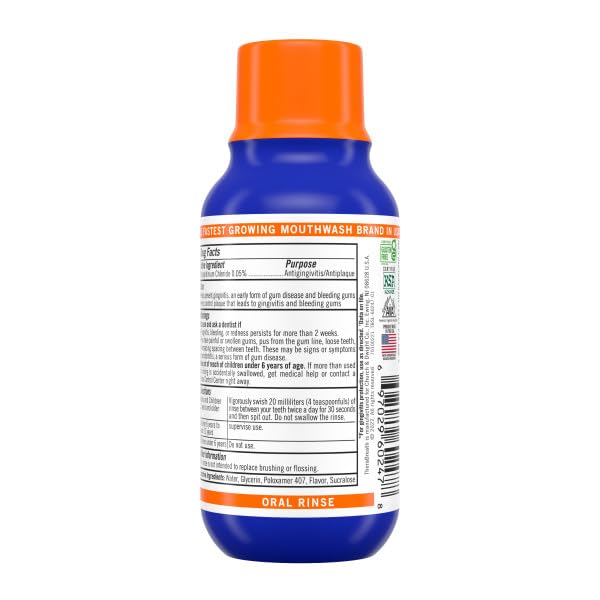 TheraBreath mouthwash swirl action near bottle background