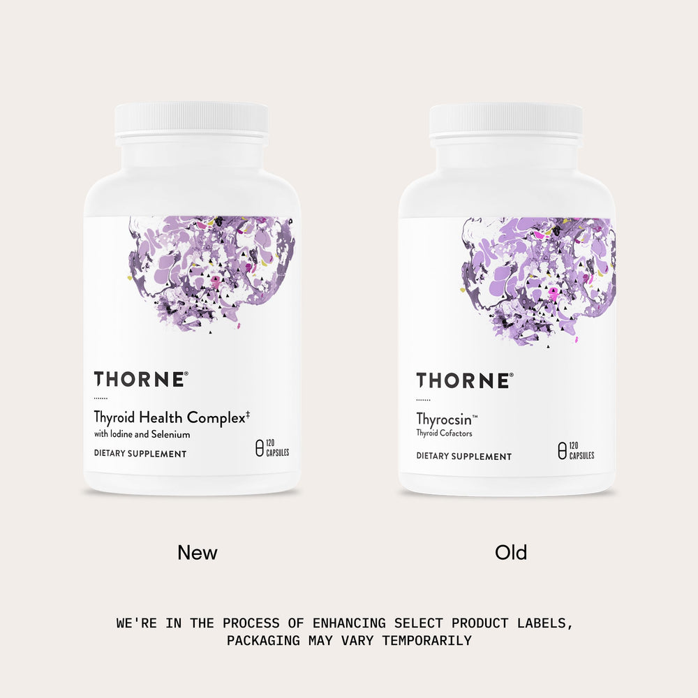Thorne Thyroid Health Complex capsules held in hand for daily use