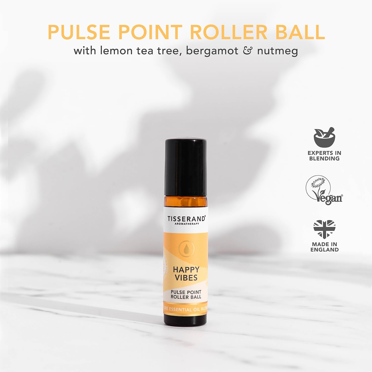 Tisserand Happy Vibes applied to the wrist for quick scent refresh.