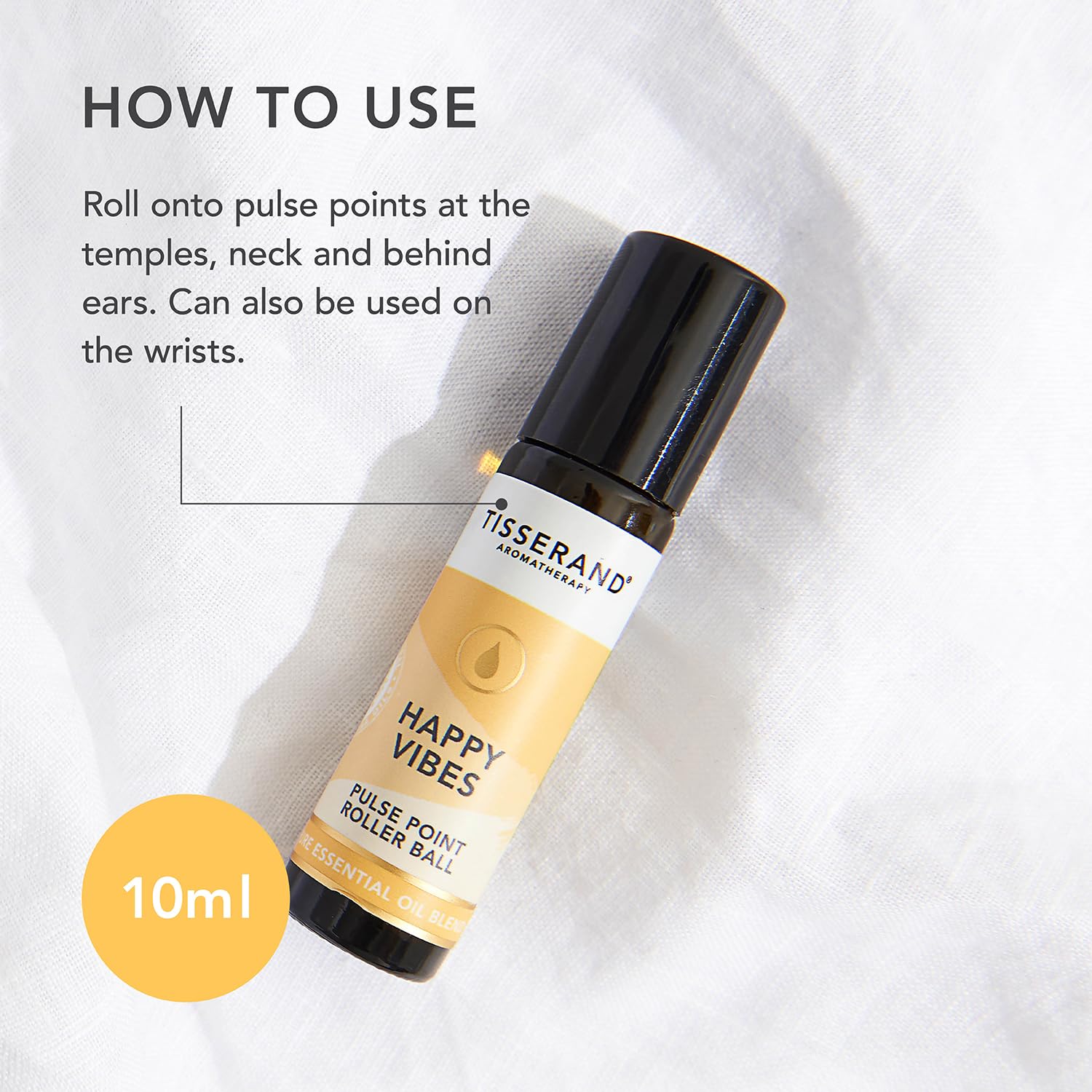 Tisserand Happy Vibes label close-up emphasizes Lemon Tea Tree notes.