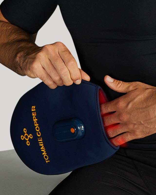 User wearing the Tommie Copper mitt during activity for targeted relief.