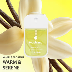 Touchland travel-size mist in hand, ideal for pocket-ready sanitizing.
