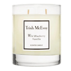 Trish McEvoy Wild Blueberry Vanilla candle in glass vessel for warm ambient fragrance.