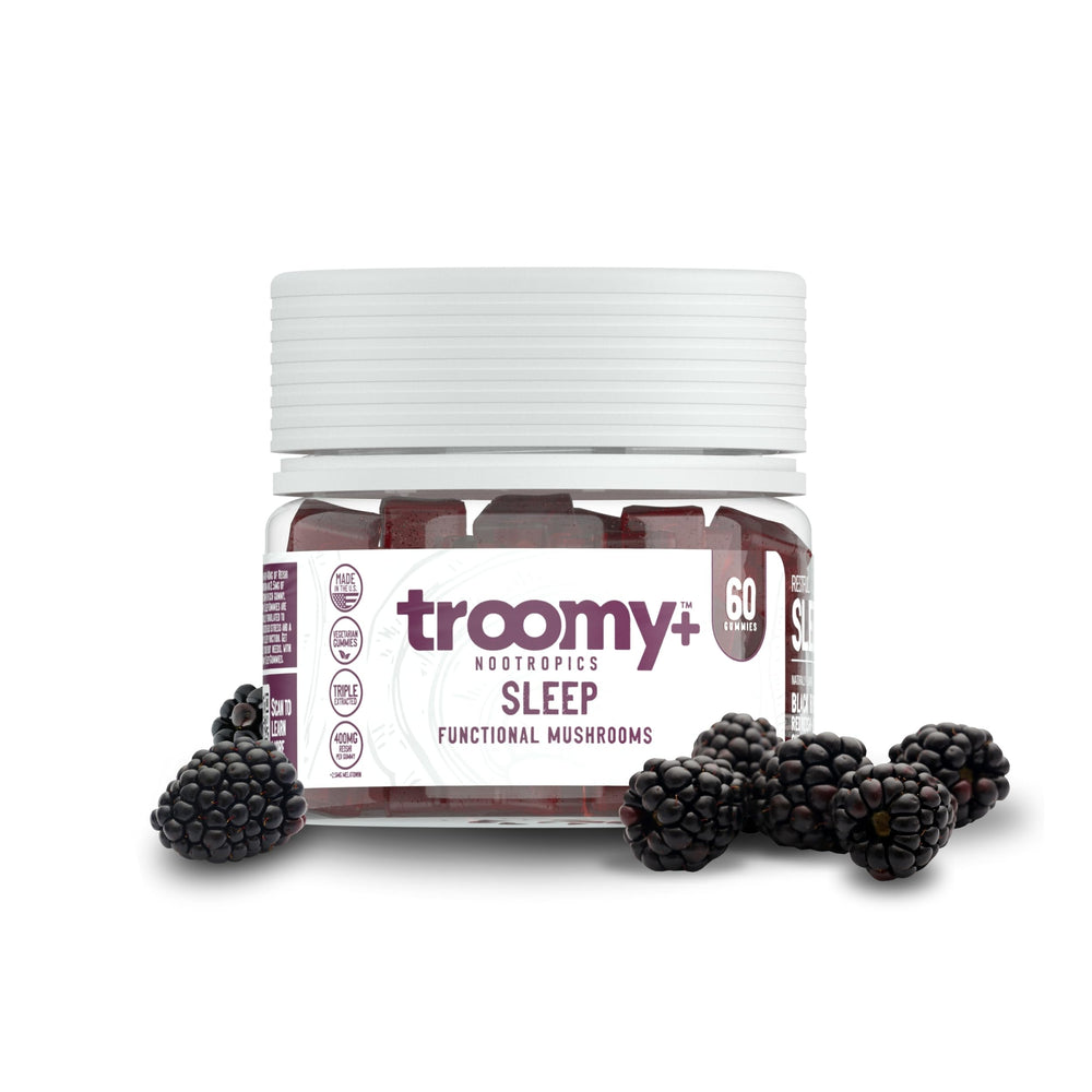 Troomy Sleep Gummies bottle on nightstand with black raspberry flavor