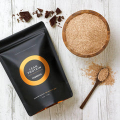 Tropeaka Lean Protein Chocolate serving scoop beside tub emphasizes convenient daily dosing.