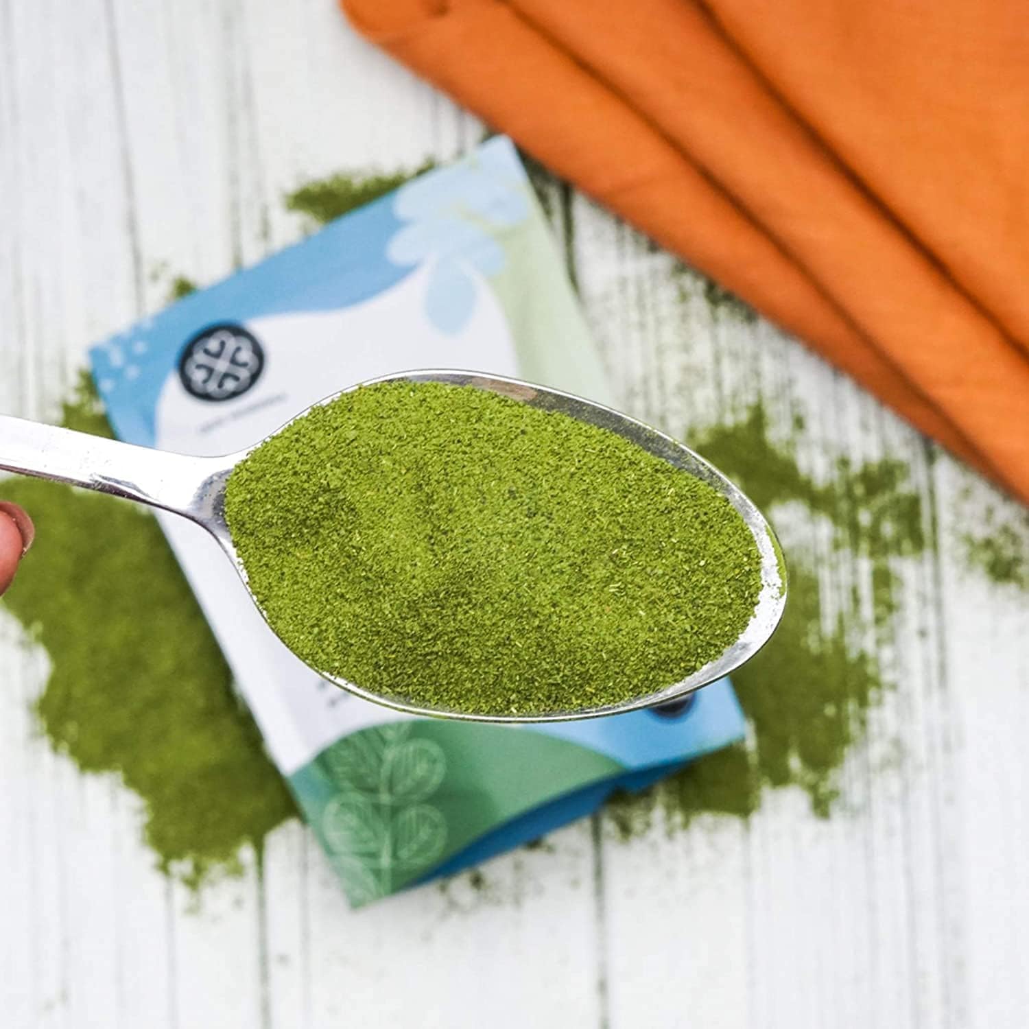 True Moringa regenerative organic moringa powder close-up highlights vibrant green leaves.