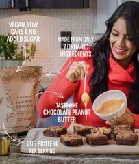 Truvani Dairy Free Protein Powder being poured into a glass for a smoothie.