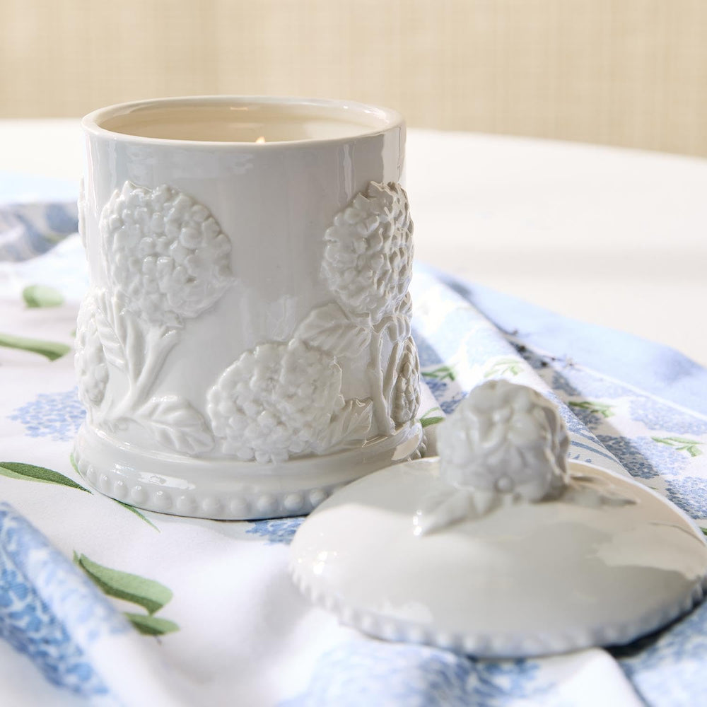 Two's Company hydrangea relief candle with intricate relief design enhances decor detail.