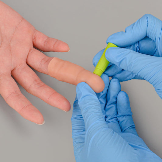 Ultrassist finger-stick trainer with protective lining prevents accidental punctures.