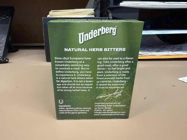 Underberg bottle wrapped in straw-paper highlighting heritage and easy sharing after meals