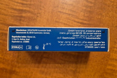 Storage and opening details of UPAX VitA-POS Eye Comfort Ointment on a nightstand.