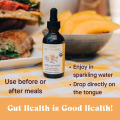 Pouring Urban Moonshine Citrus Digestive Bitters into a glass for digestion support.