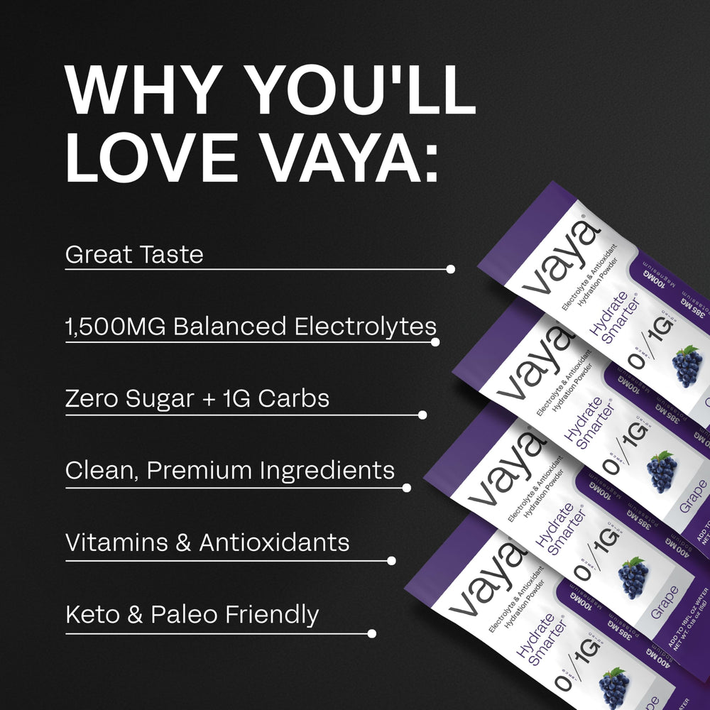 Pouring Vaya grape electrolyte packet into water for refreshment
