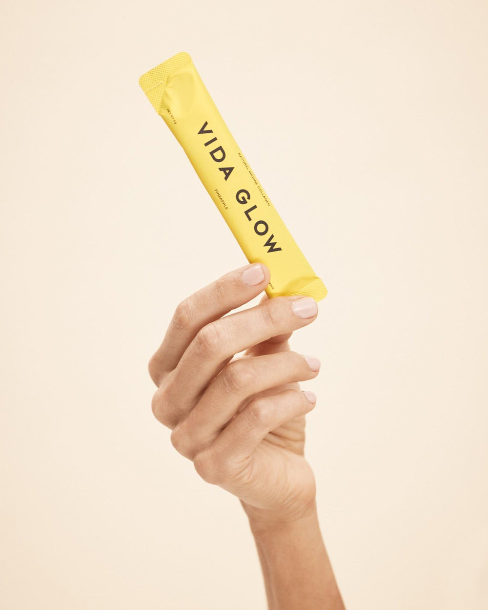 Vida Glow collagen powder with dispensing scoop for easy daily measurement.
