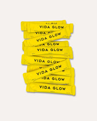 Vida Glow collagen sachet opening showing convenient on the go packaging.