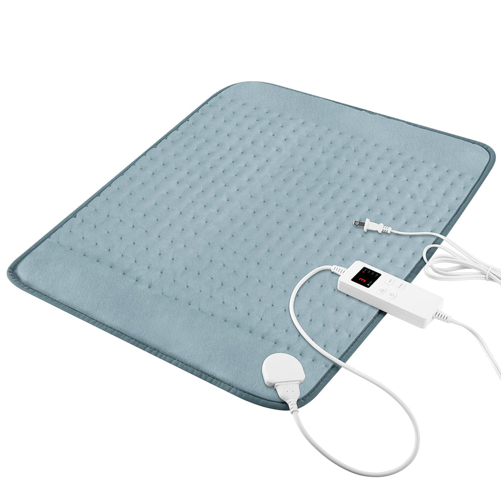 Vilicert heating pad on bed with gray cover for cramp relief and relaxation.