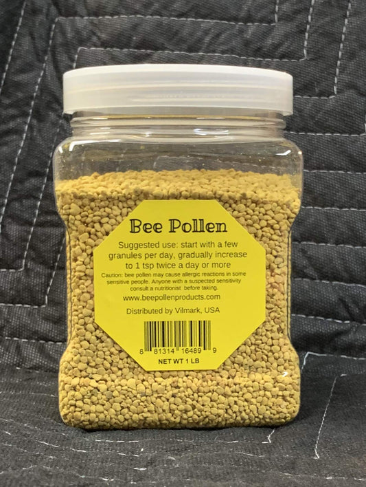 Vilmark Bee Pollen granules closeup on a spoon, ready to blend into smoothies.