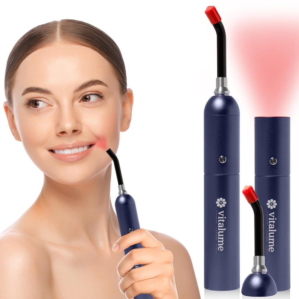 Vitalume red light wand in hand showing a compact design for on-the-go therapy.