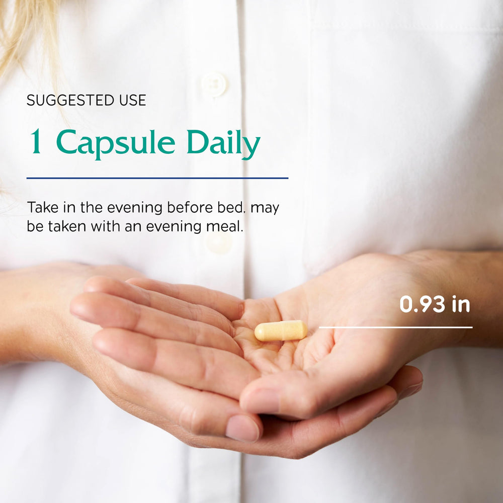 Lifestyle shot of someone taking Ovum P.M. capsule before bed.