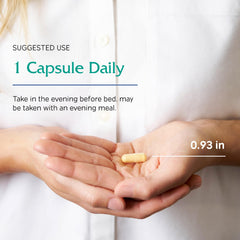 Lifestyle shot of someone taking Ovum P.M. capsule before bed.