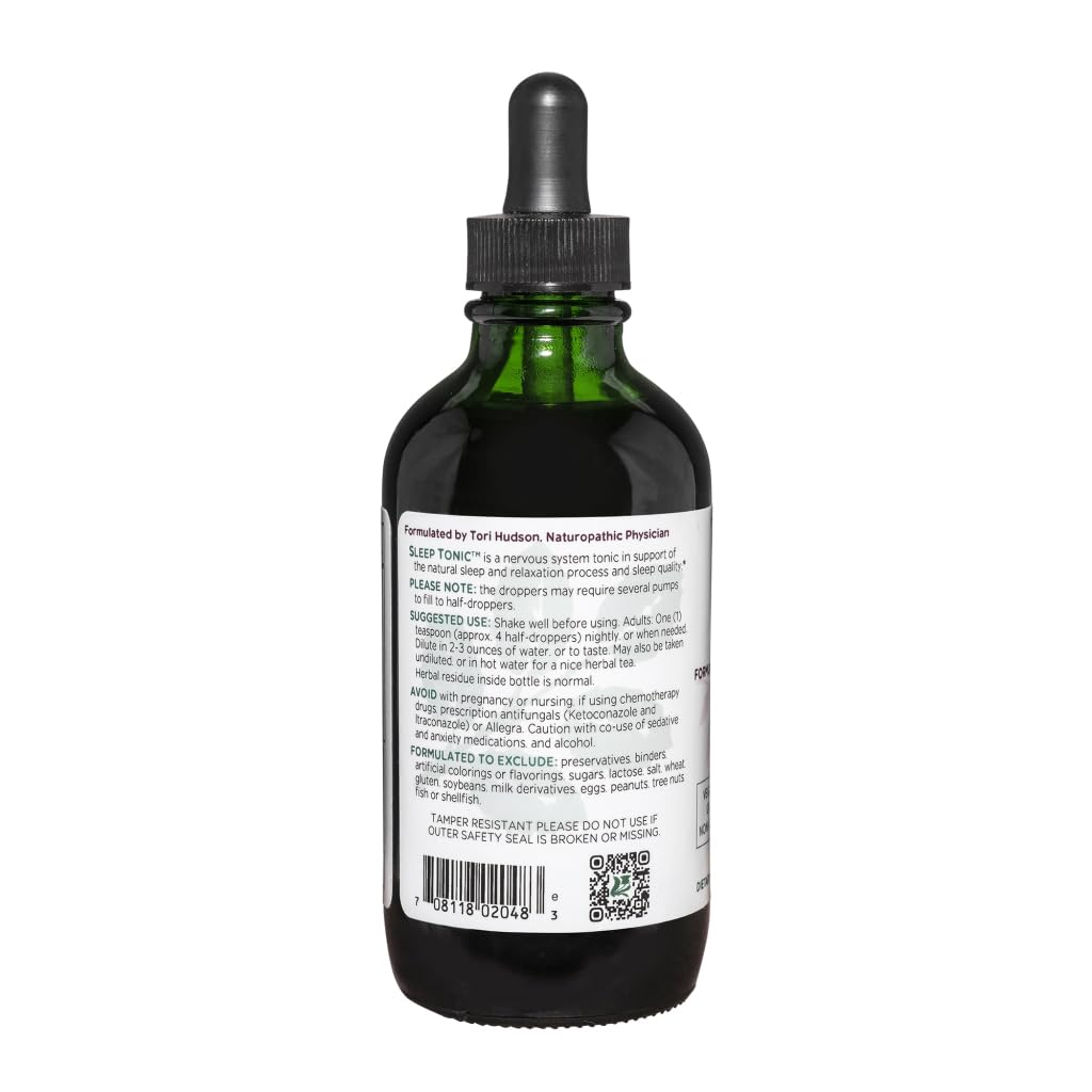 Liquid Sleep Tonic swirling in a glass with a soft amber color