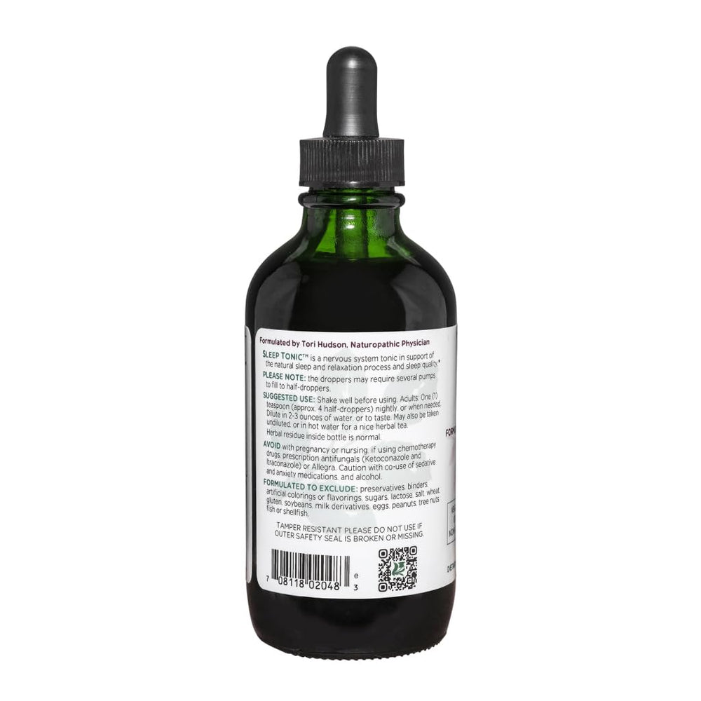 Liquid Sleep Tonic swirling in a glass with a soft amber color