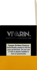 Vivarin bottle beside a glass signaling caffeine boost