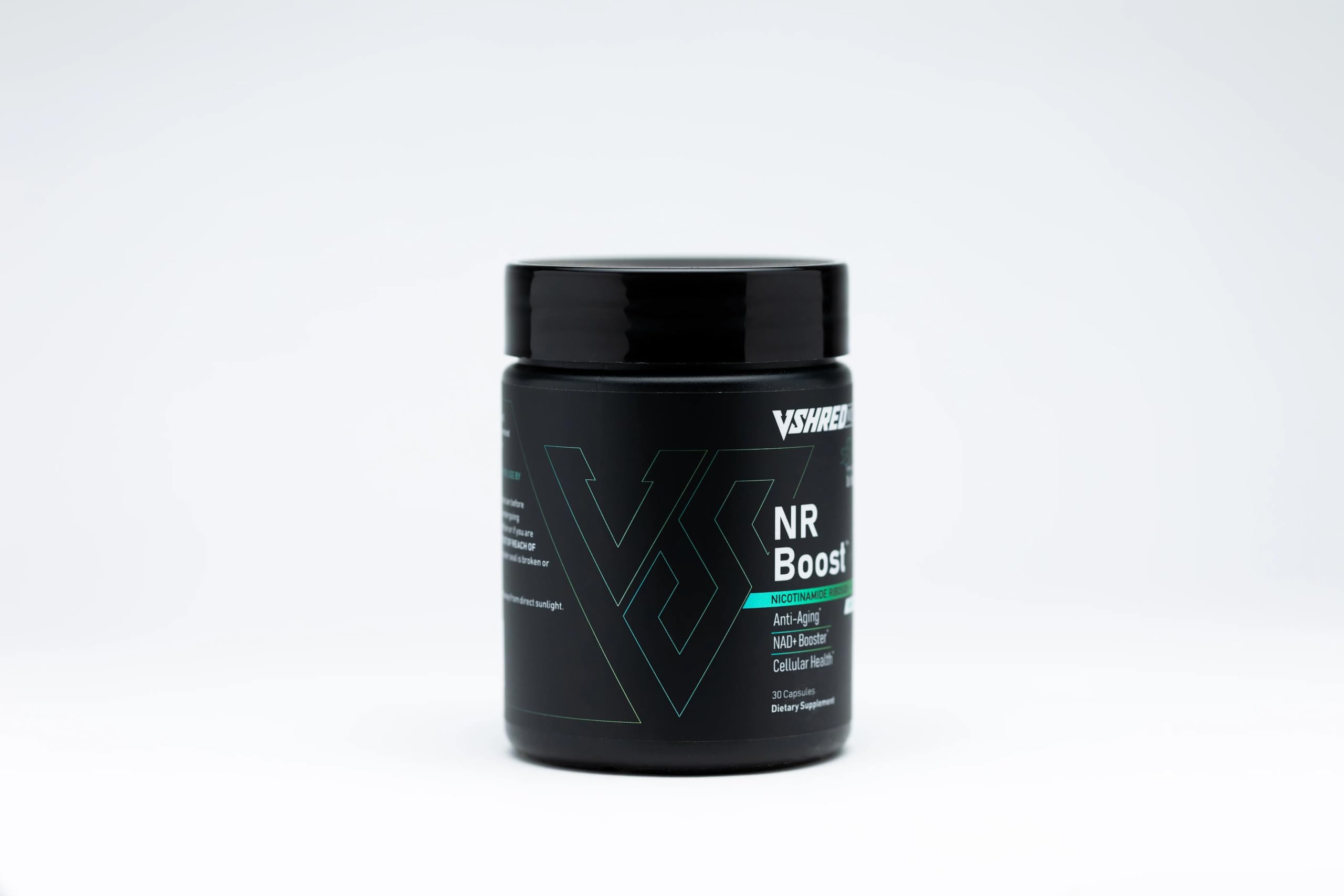 V Shred MD NR Boost capsules on a clean surface highlighting vitality.