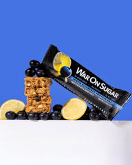 War on Sugar Lemon Blueberry bar on a desk, ready for post-workout snacking.