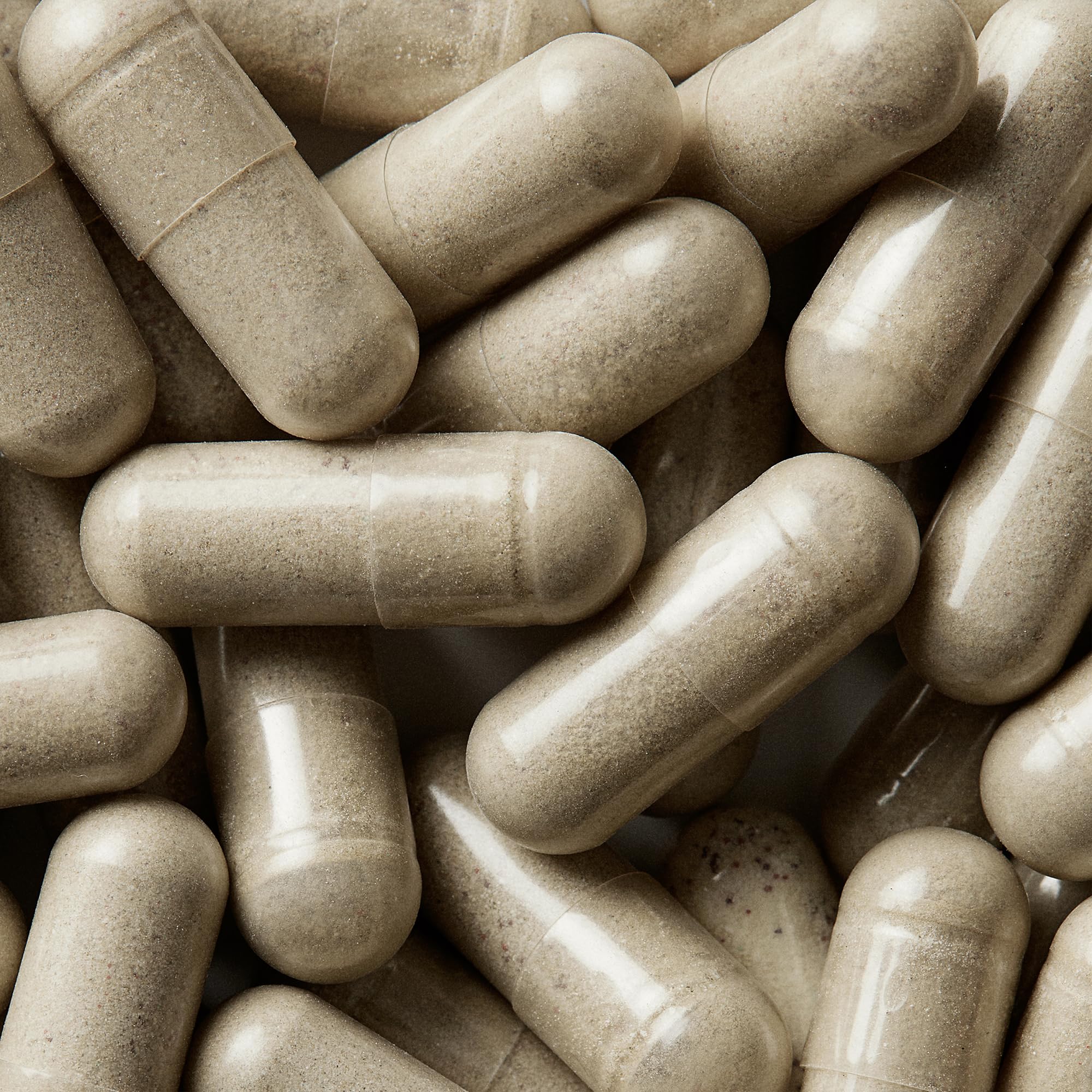 Wellbel Women+ capsule close-up showing plant-based, drug-free formula.