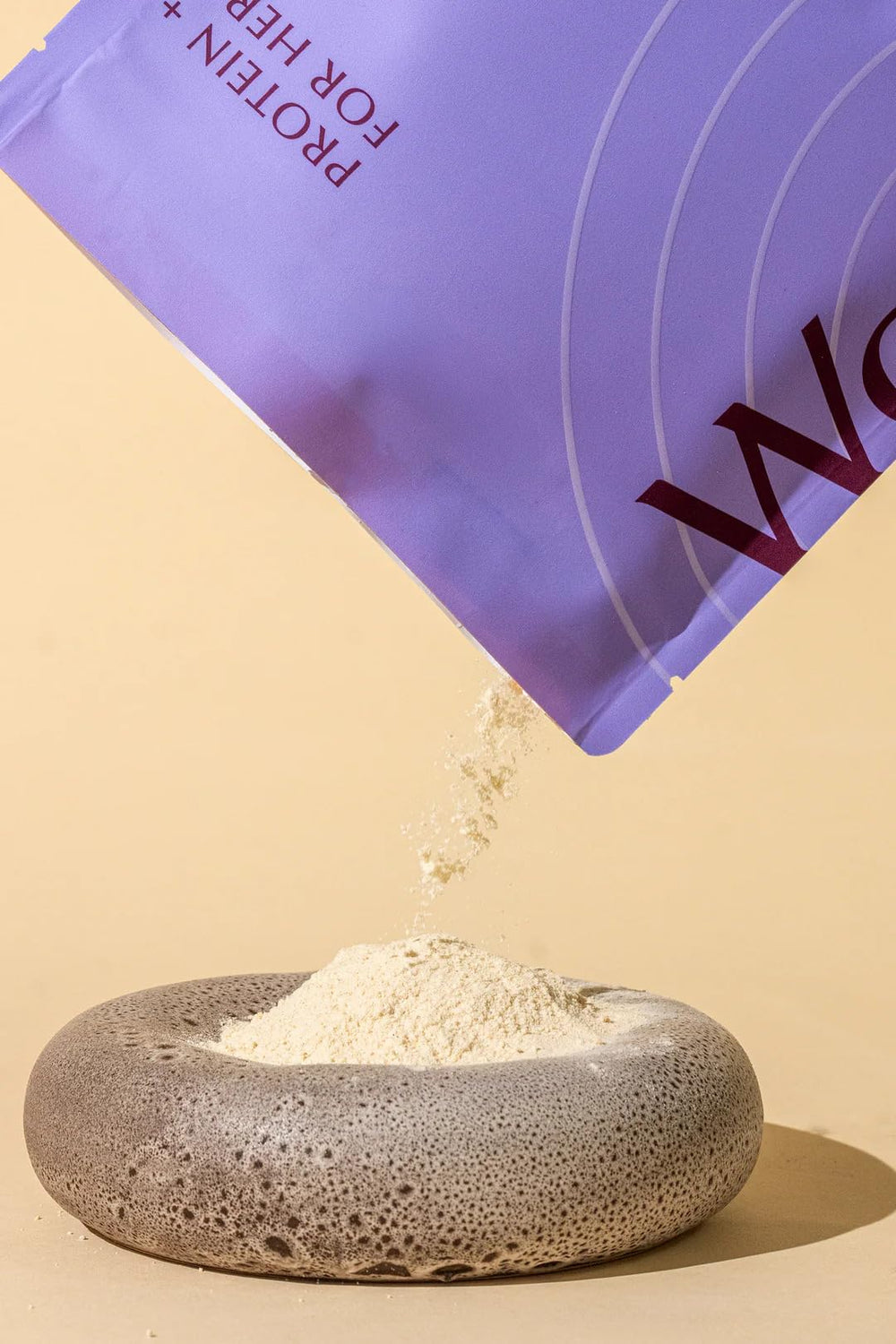 Spoon scooping WeNatal Prenatal Protein+ for Her vanilla powder for daily protein