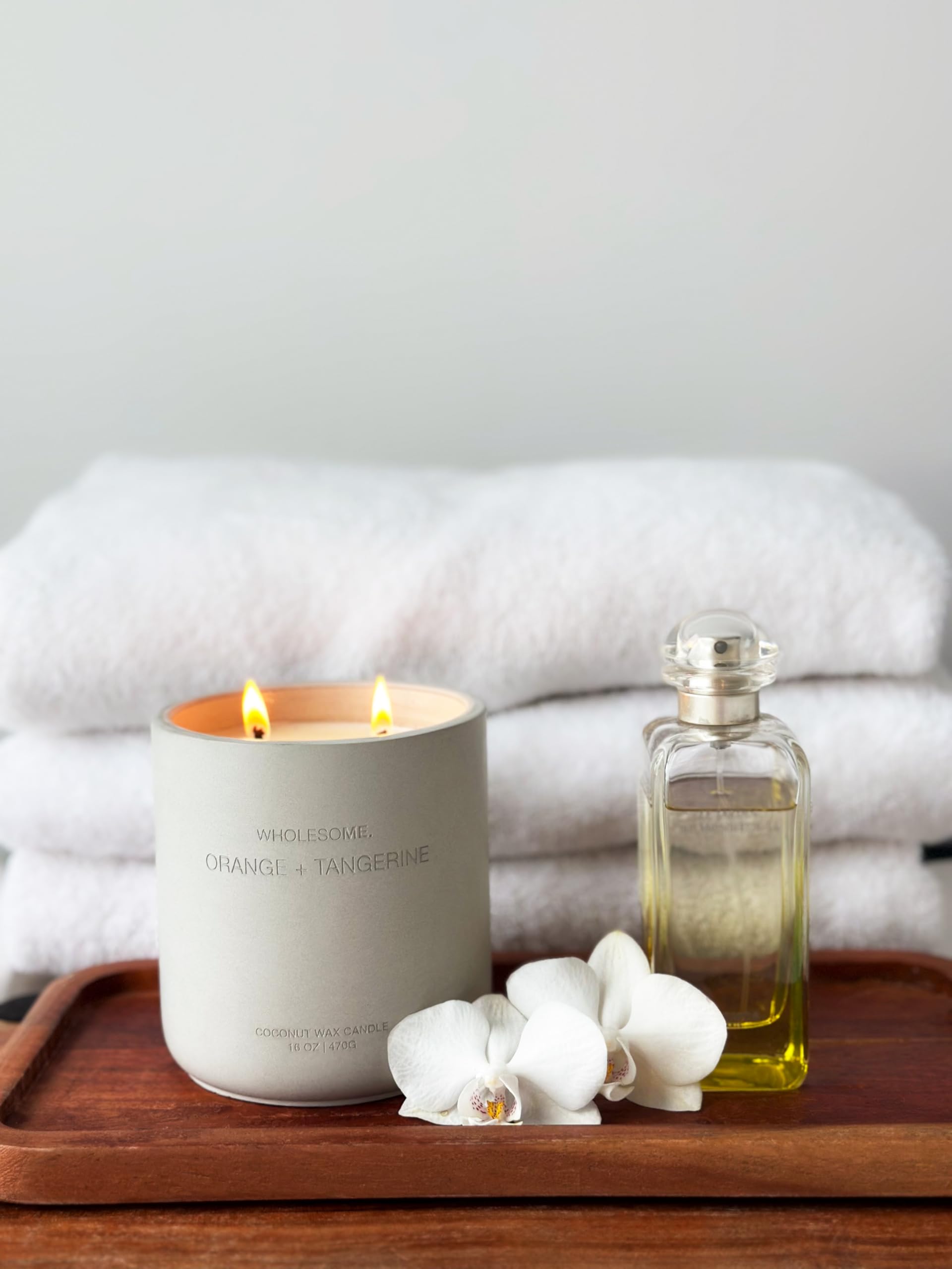 Warm amber glow of WHOLESOME candle in concrete jar during relaxation