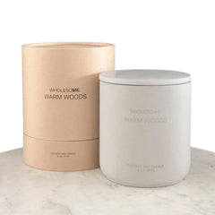 WHOLESOME Warm Woods candle in a concrete jar close-up for cozy living spaces.