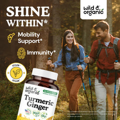 Wild & Organic ingredients close-up showing turmeric and ginger roots with capsules.