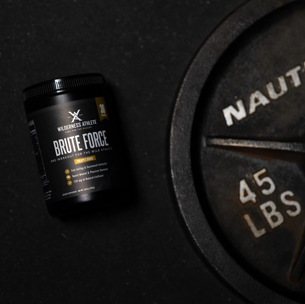 Wilderness Athlete Brute Force amino blend scoop highlights strength-focused benefits during training.