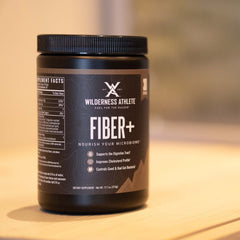 Wilderness Athlete Fiber+ measuring scoop beside breakfast ingredients for fiber-friendly start