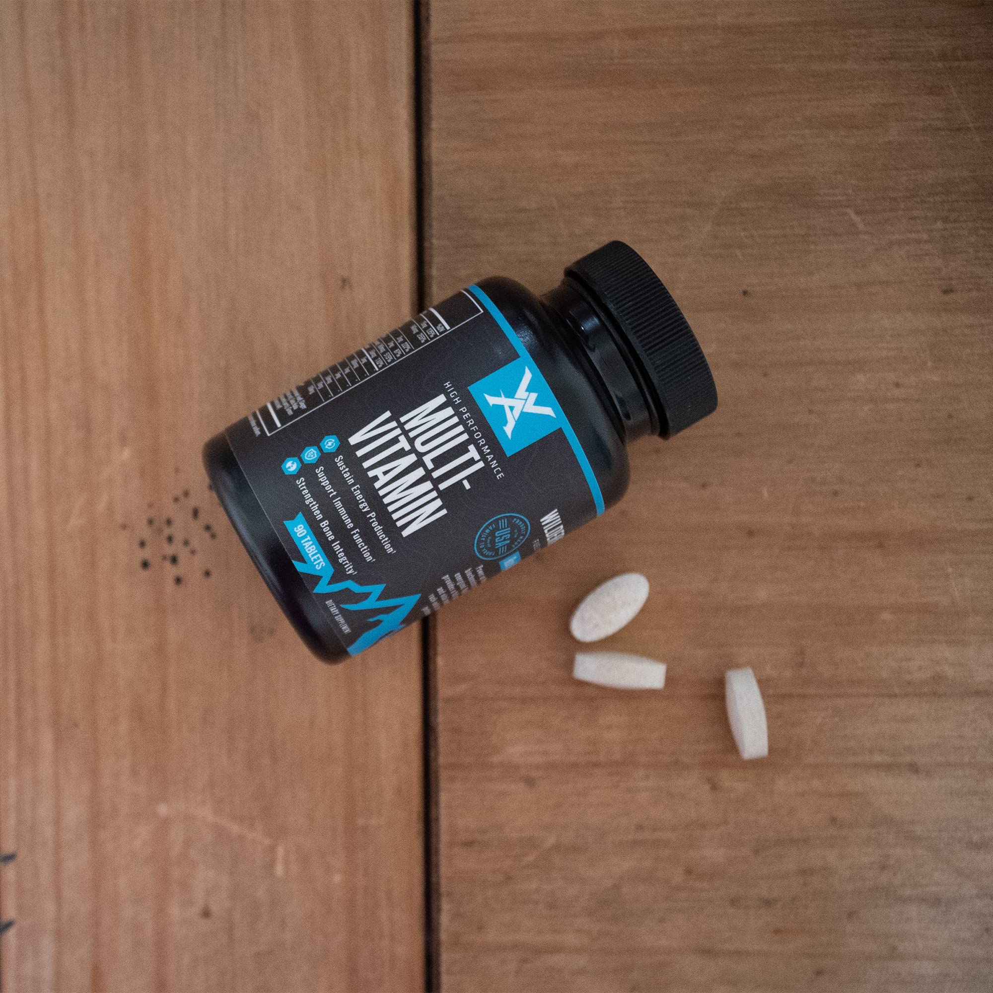 Wilderness Athlete High Performance Multivitamin bottle pouring capsules for daily replenishment.