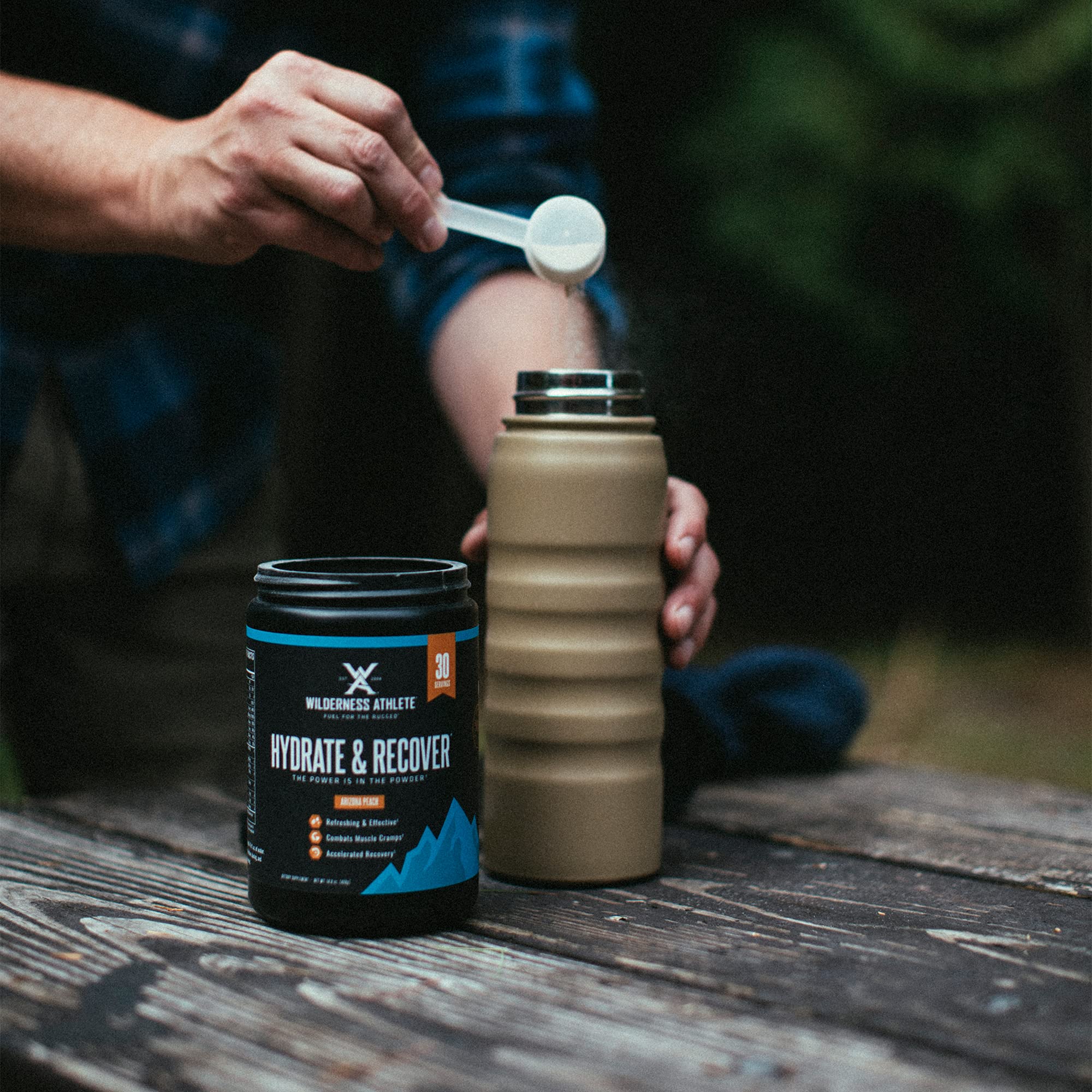 Glass of blue raspberry Wilderness Athlete drink highlighting electrolyte beverage.