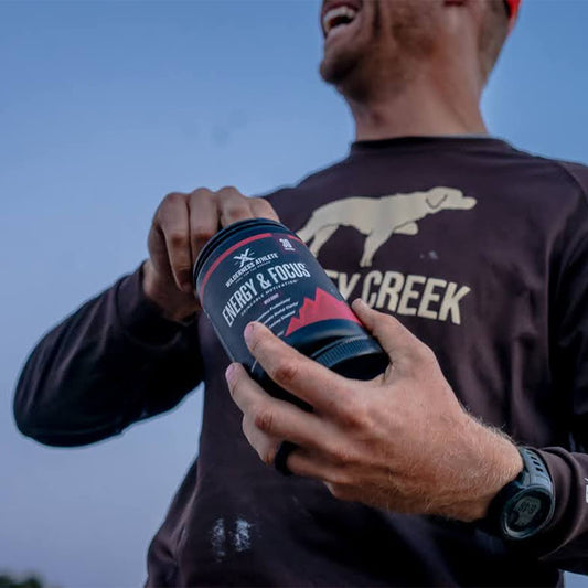 Wilderness Athlete Mango Bango drink glass showing zero sugar refreshment for focus
