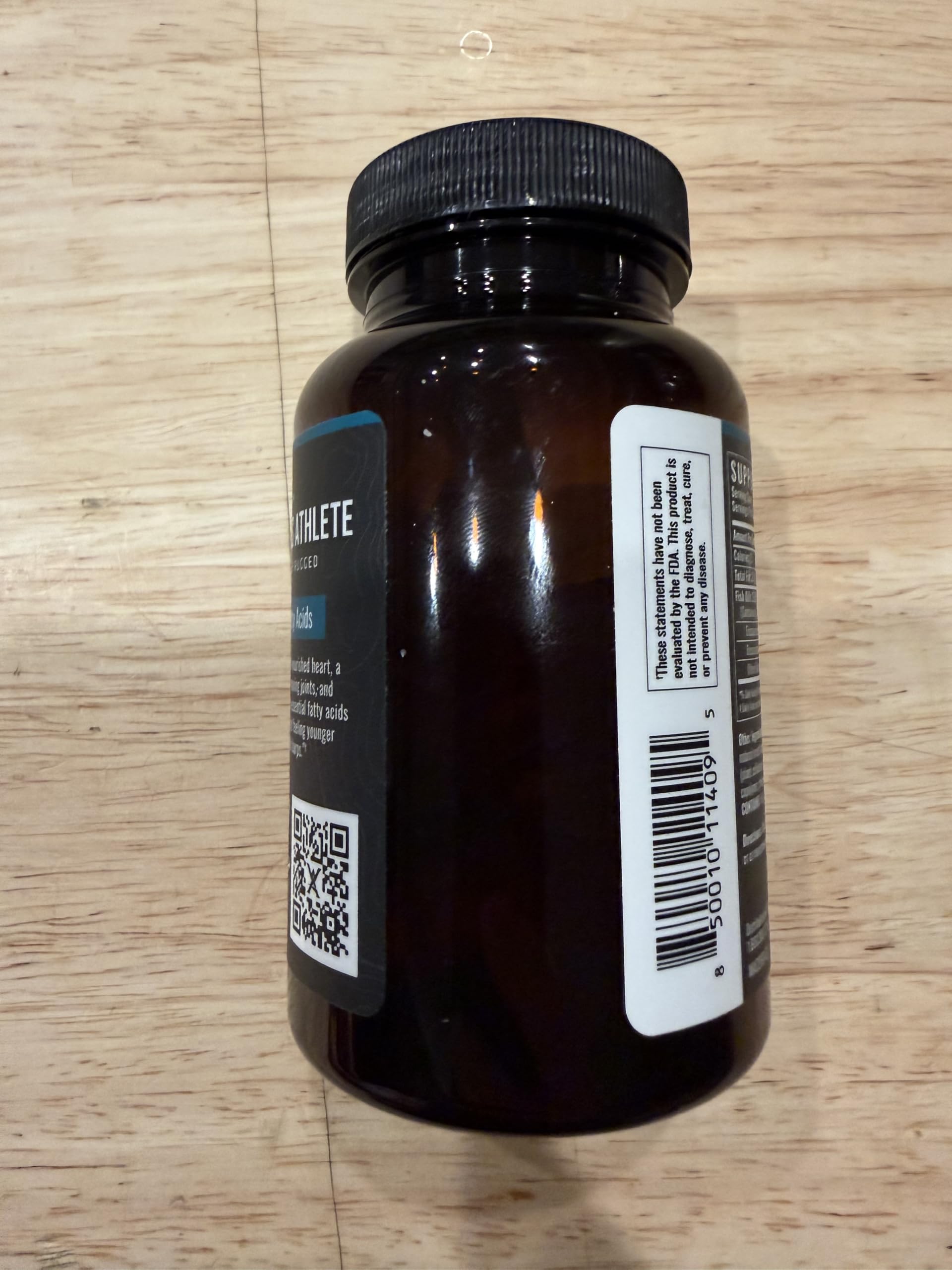 Wilderness Athlete Omega-3 bottle pouring softgels for daily use