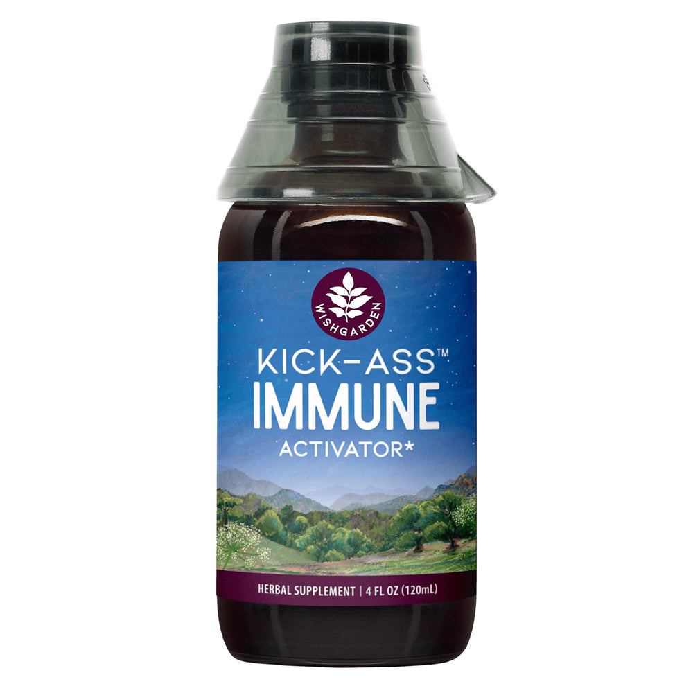 WishGarden Kick-Ass Immune Activator bottle with herbal blend on desk.