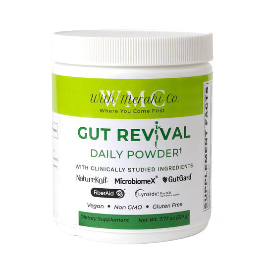 With Meraki Co. Gut Revival bottle closeup for supporting microbiome balance and digestive wellness.