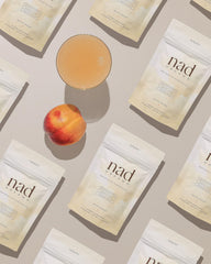 Xyngular NAD Dreams peach flavor in glass conveys relaxing bedtime ritual.