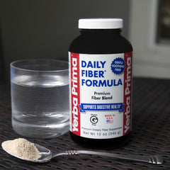 Pouring Yerba Prima Daily Fiber Formula into a glass for a fiber-rich drink.